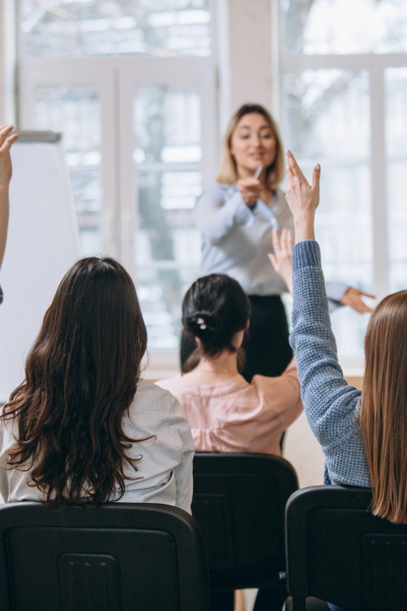 female-speaker-giving-presentation-hall-university-workshop-audience-conference-hall